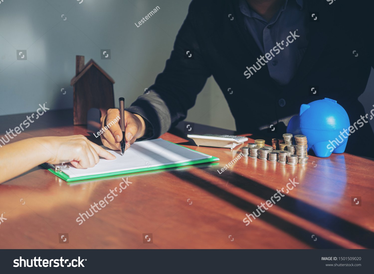 stock-photo-businessman-buying-and-selling-houses-and-real-estate-prices-concept-business-signing-a-contract-1501509020