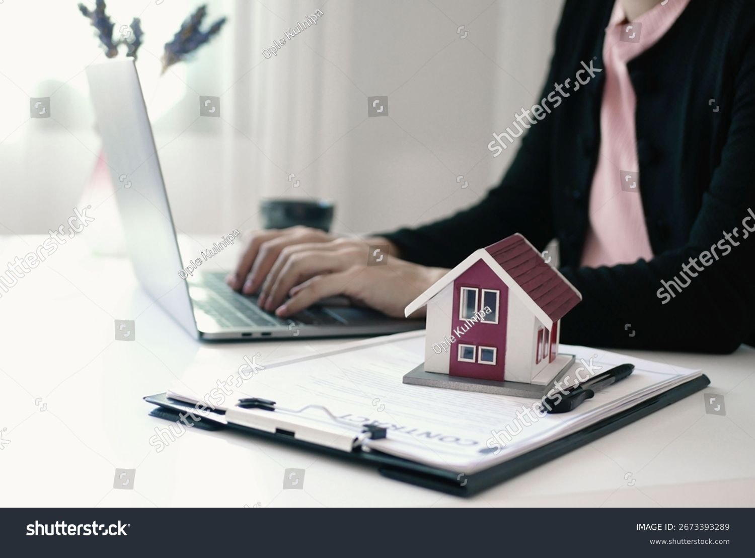 stock-photo-real-estate-agent-signs-documents-and-gives-home-insurance-advice-create-a-home-purchase-insurance-2673393289